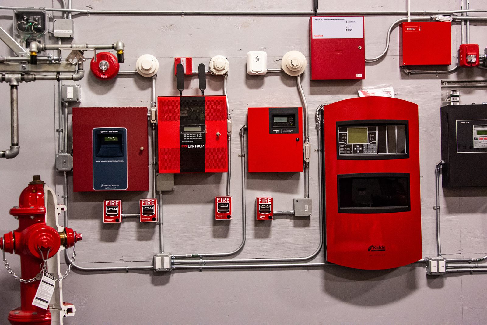 Fire alarm and hydrant panels on a wall