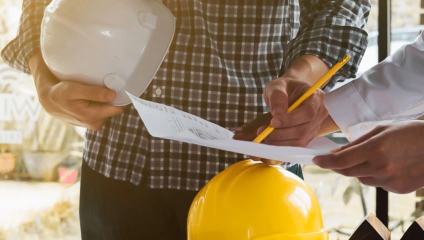 Engineer reviewing project plans on site