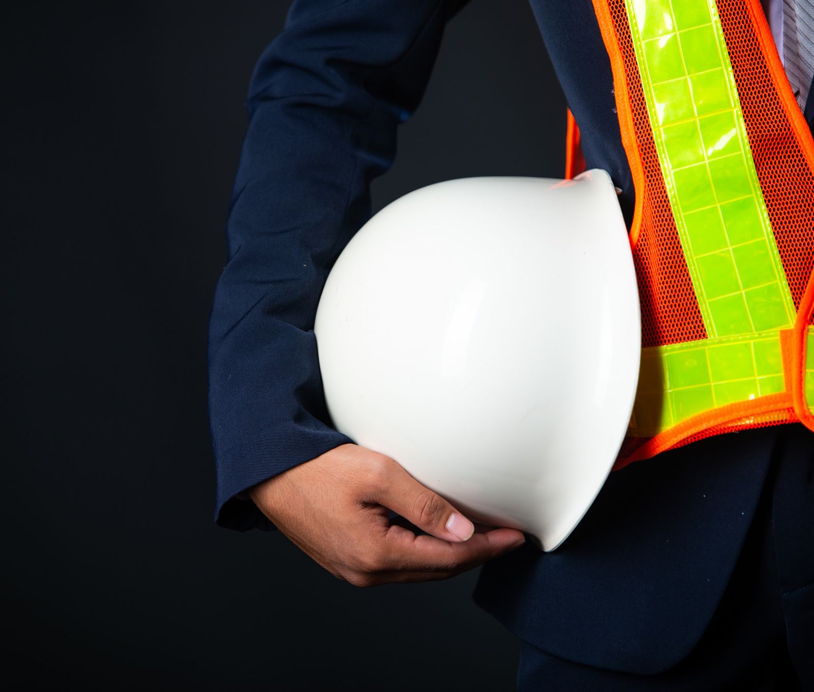 Safety professional holding a white helmet